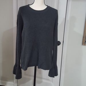 Grey shaker knit sweater with ruffle cuff